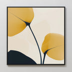 Golden Leaves Canvas Art features two abstract yellow leaves with dark stems on a light background, framed in black. Its minimalist, modern design is ideal for living room decor, adding clean lines and subtle color contrast to your space.
