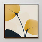 Golden Leaves Canvas Art features two abstract yellow leaves with dark stems on a light background, framed in simple wood—ideal modern decor to add style to your living room.