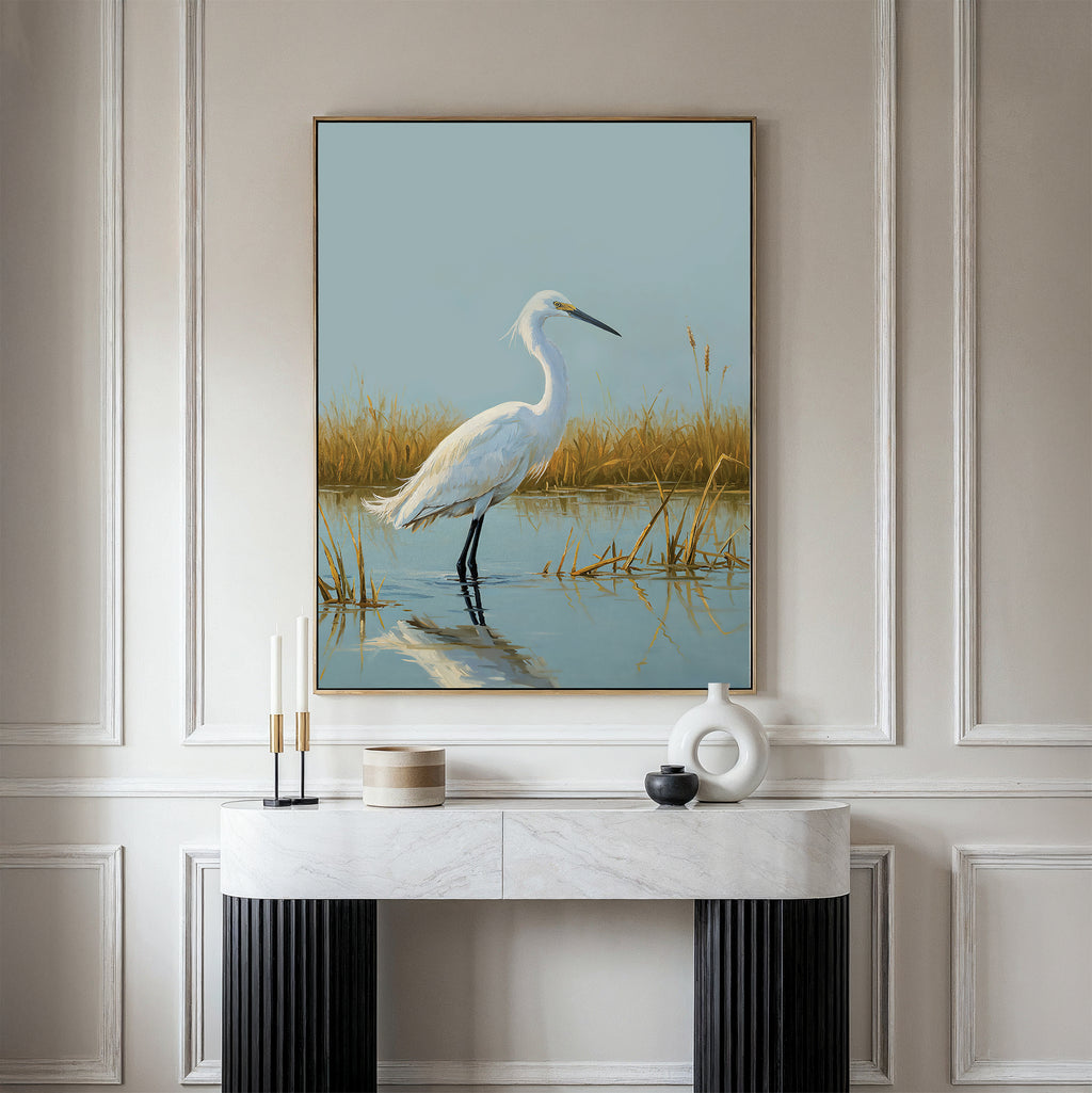 The Golden Marsh Egret Canvas Art features a white heron in shallow water among tall dry grass, making it perfect for adding serene and elegant decor above a modern console table.