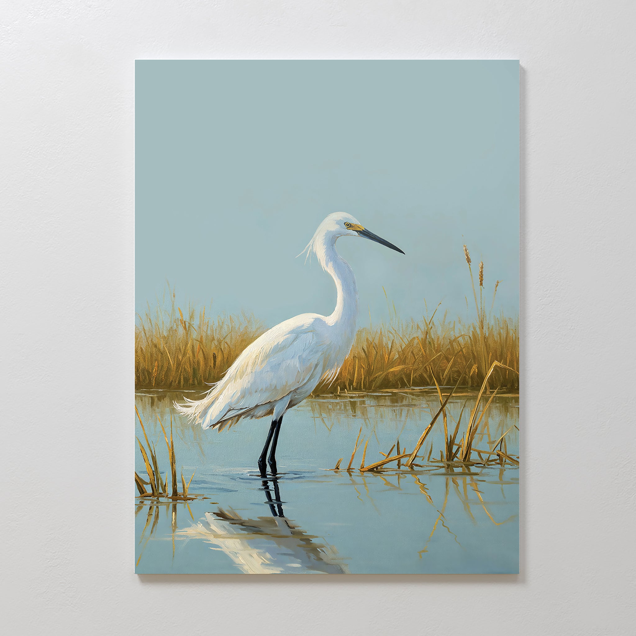 Golden Marsh Egret Canvas Art captures a white egret standing in shallow water among golden reeds, reflected on a calm surface beneath a pale blue sky—an elegant touch for tranquil home decor.