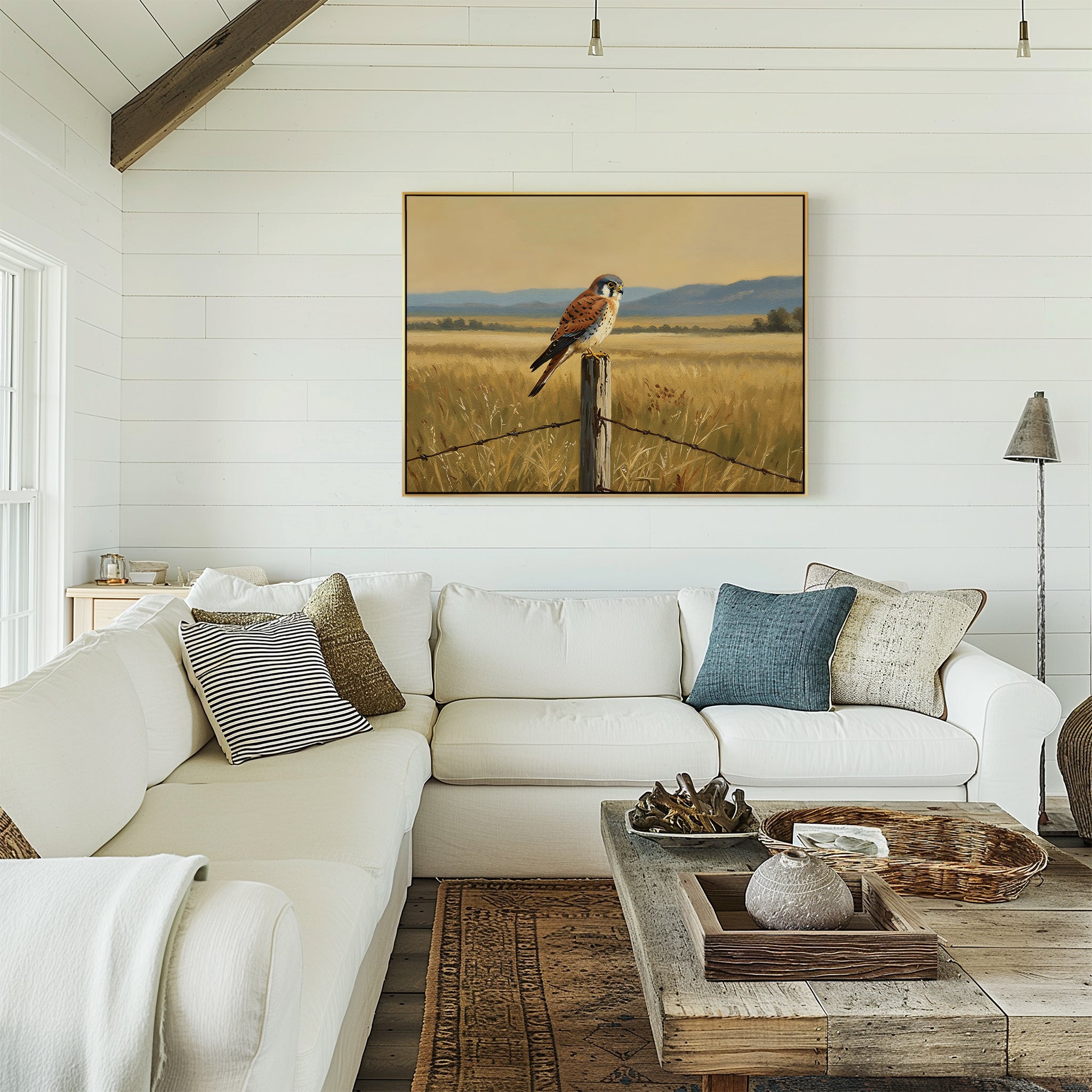 A bright, cozy living room with a white sectional sofa, rustic wooden coffee table, and the Golden Plains Canvas Art—a nature-inspired painting—hanging on the white shiplap wall above the couch.