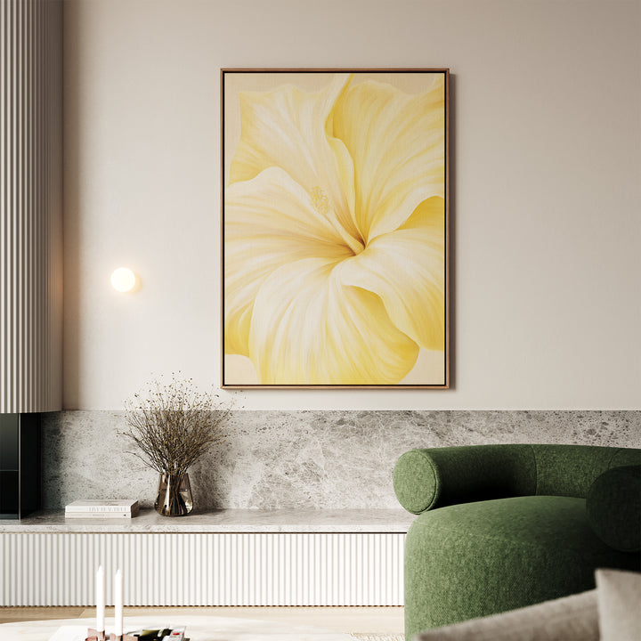A modern living room with a green sofa, a low marble-topped bench, dried flowers in a vase, and the Golden Radiance Canvas Art featuring a soft yellow flower as the centerpiece on the wall.