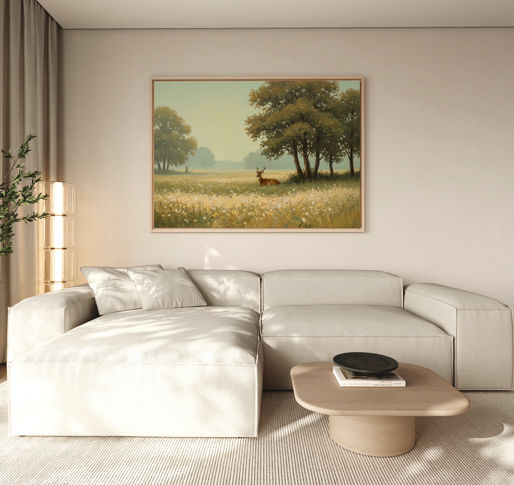 A modern living room featuring a light-colored sectional, a wooden coffee table, and the Golden Rest Canvas Art—a print of a serene deer in a sunlit meadow—creating cozy interiors with tranquil vibes above the couch.