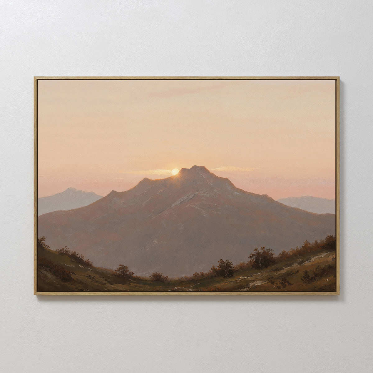 Golden Summit Canvas Art is a framed mountain landscape at sunset in soft orange and pink tones, displayed on a white wall—ideal landscape wall art to enhance your living room or bedroom decor.