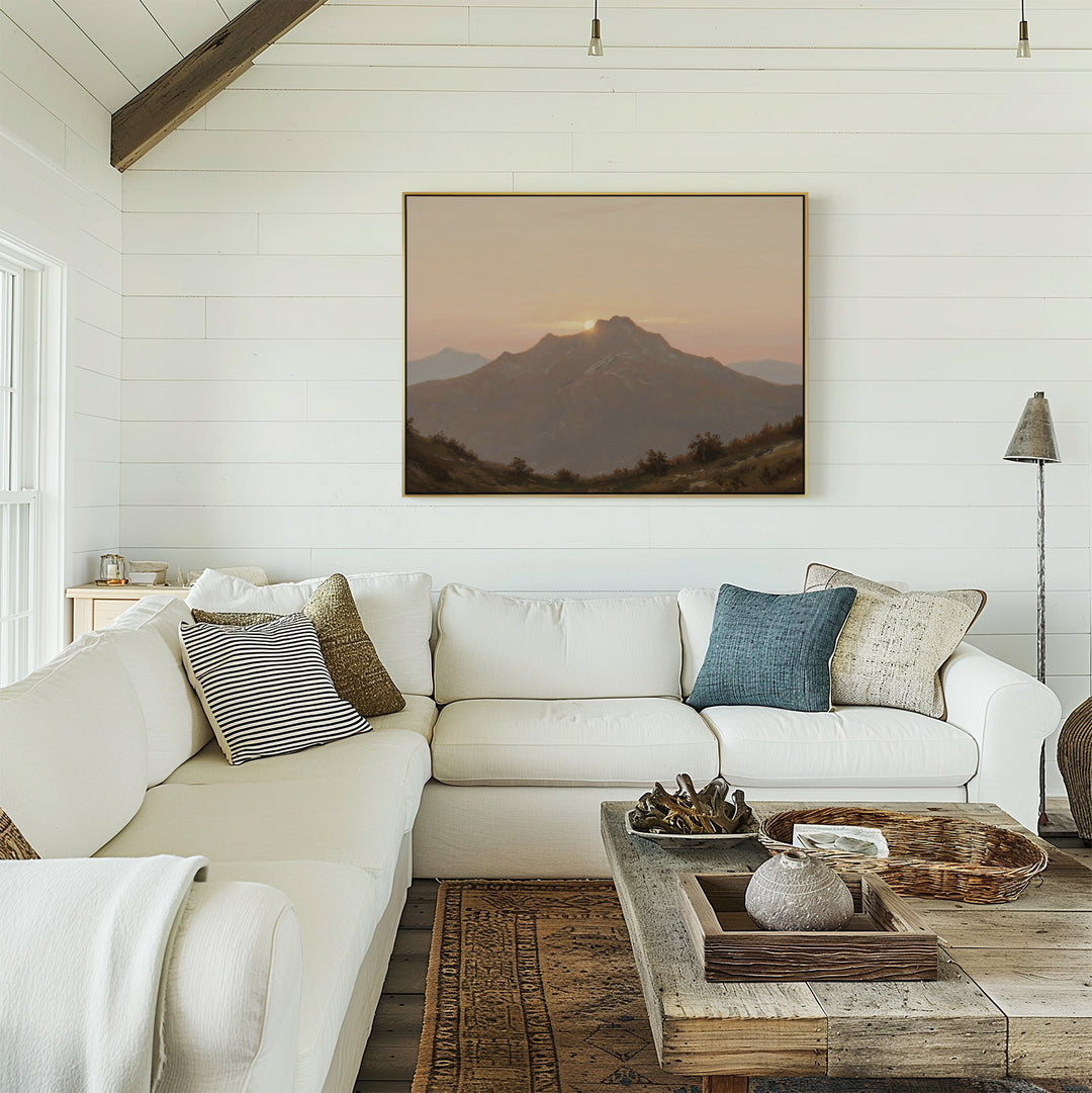 A bright, cozy living room features white shiplap walls, a white sectional with assorted pillows, a rustic wooden coffee table, and the Golden Summit Canvas Art hanging above the couch—perfect inspiration for your living room decor.