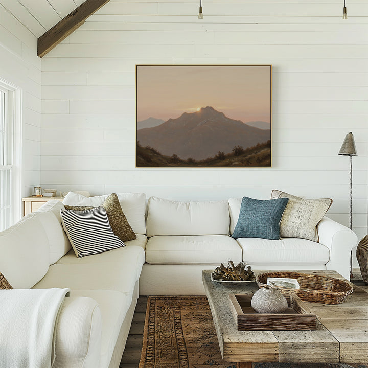 A bright, cozy living room features white shiplap walls, a white sectional with assorted pillows, a rustic wooden coffee table, and the Golden Summit Canvas Art hanging above the couch—perfect inspiration for your living room decor.