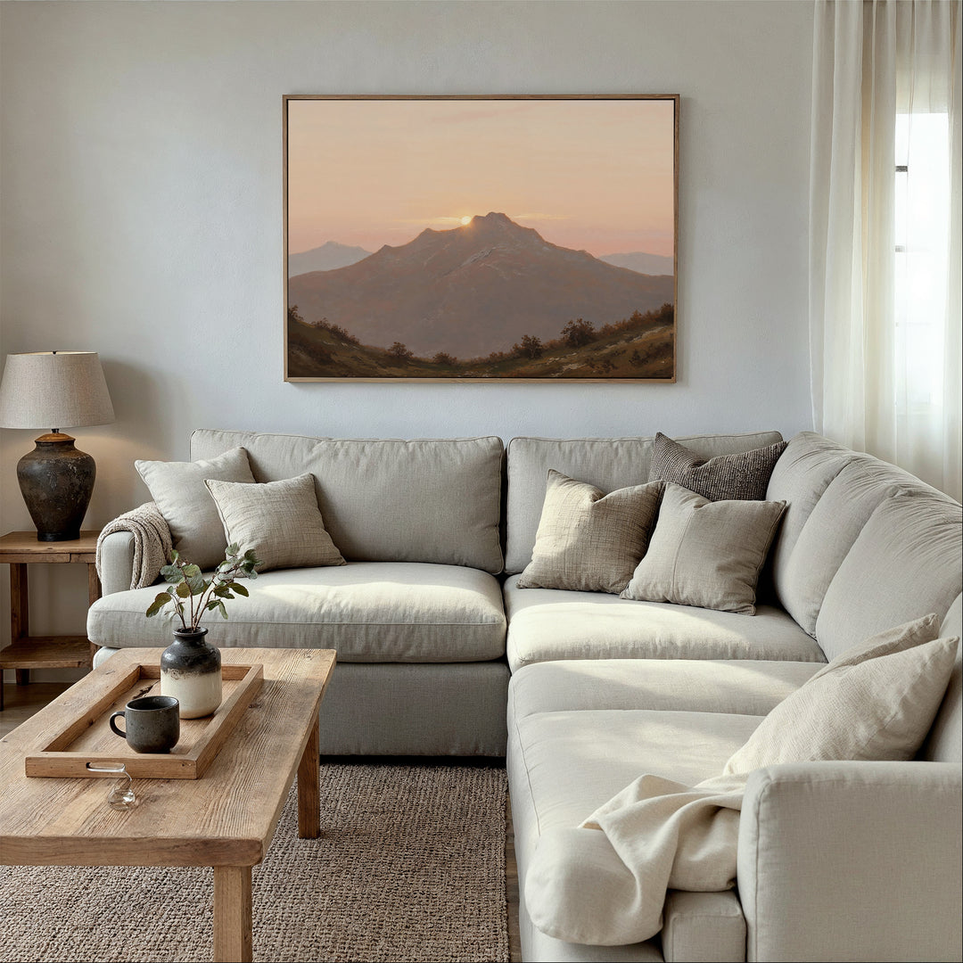 A cozy living room with a light gray sectional, neutral pillows, a wooden coffee table with vase and mugs, a table lamp, and the Golden Summit Canvas Art above the sofa—perfect inspiration for your living room decor.