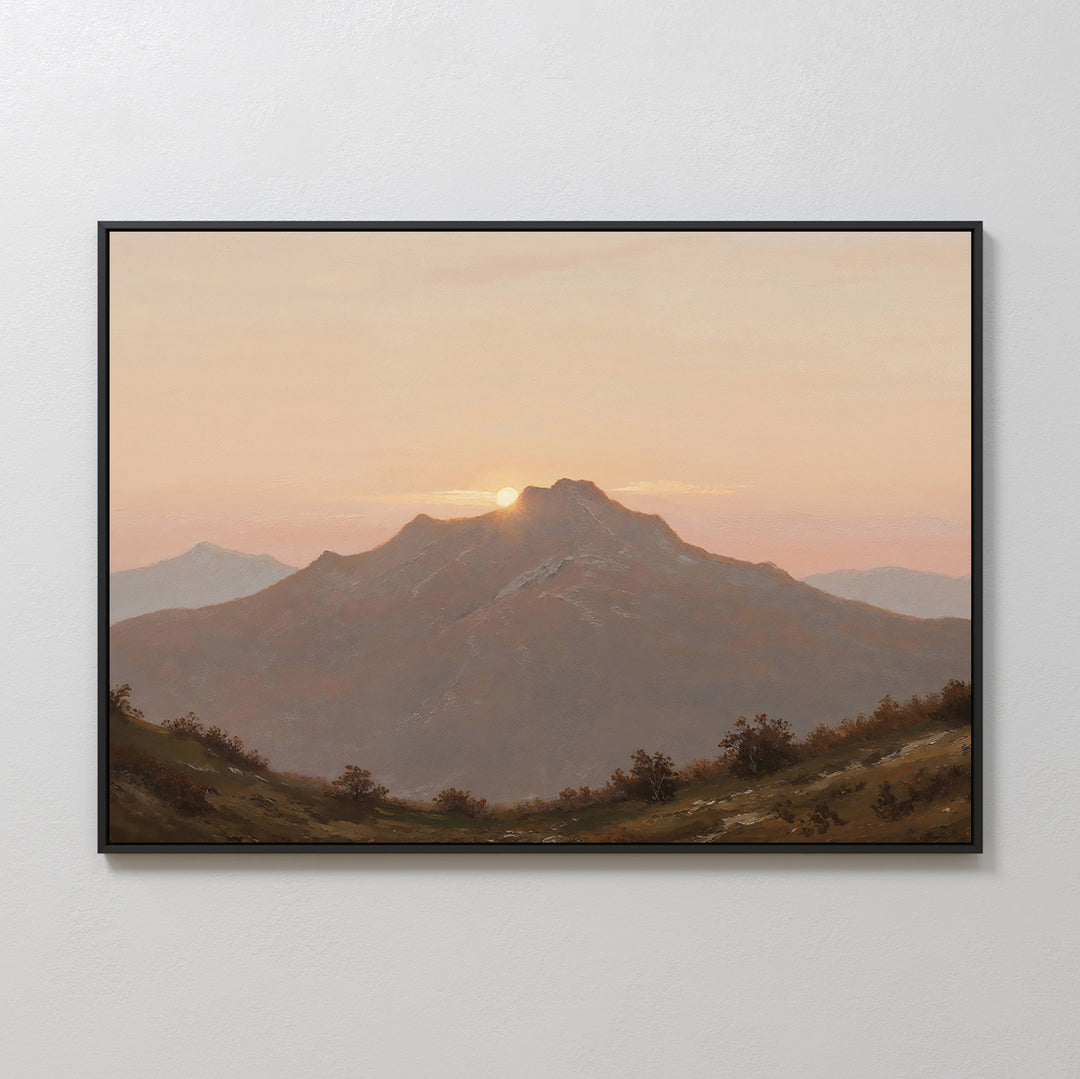 Golden Summit Canvas Art features a mountain at sunset with the sun behind the peak and a pastel sky. Shrubs and rolling hills complete this framed wall art, perfect for living room or bedroom decor.
