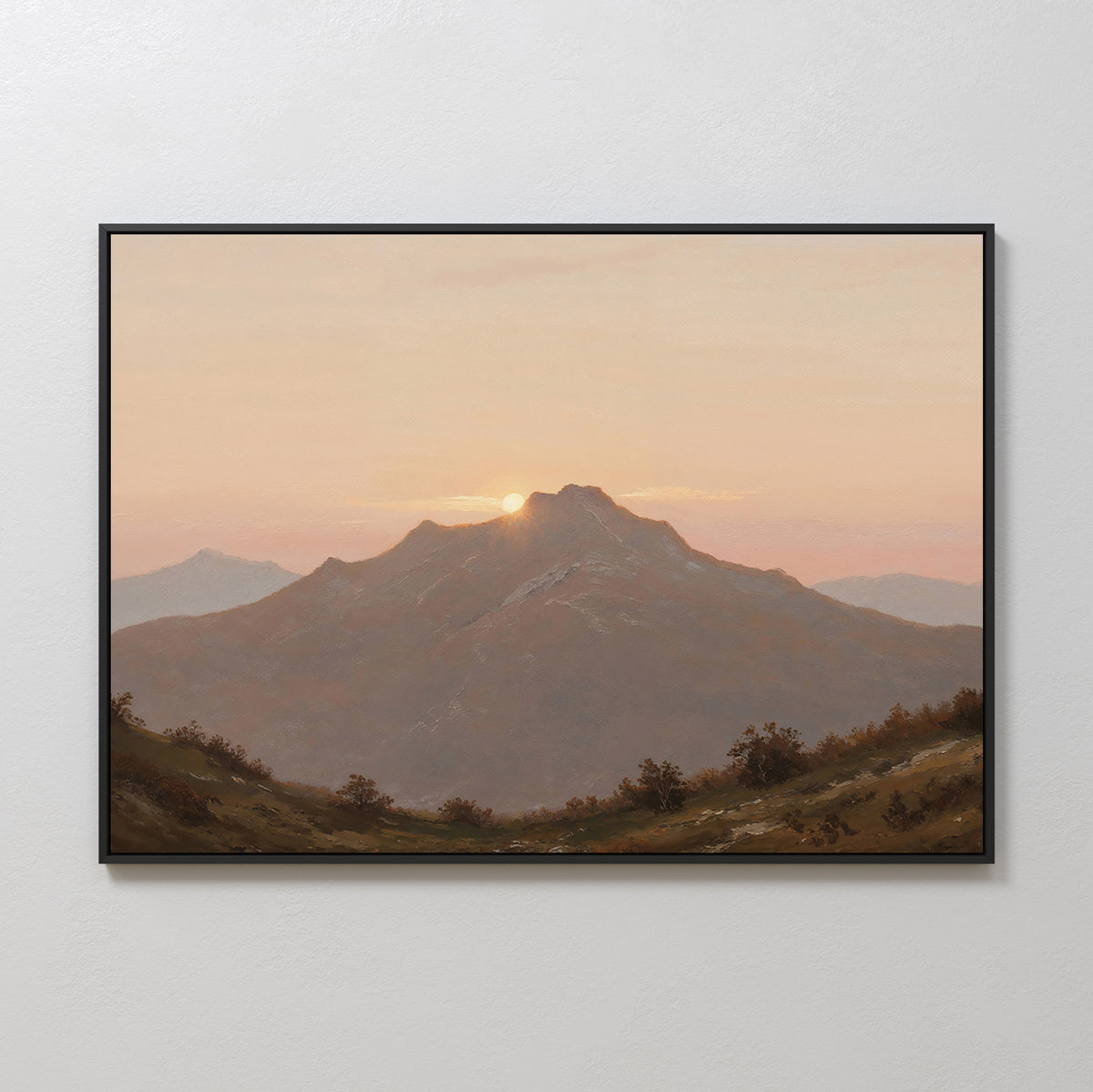 Golden Summit Canvas Art features a mountain at sunset with the sun behind the peak and a pastel sky. Shrubs and rolling hills complete this framed wall art, perfect for living room or bedroom decor.