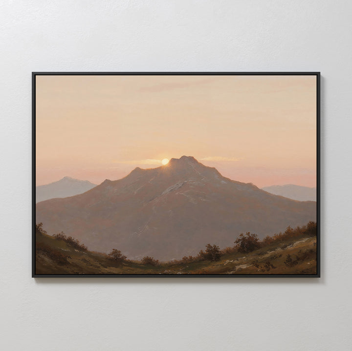 Golden Summit Canvas Art features a mountain at sunset with the sun behind the peak and a pastel sky. Shrubs and rolling hills complete this framed wall art, perfect for living room or bedroom decor.