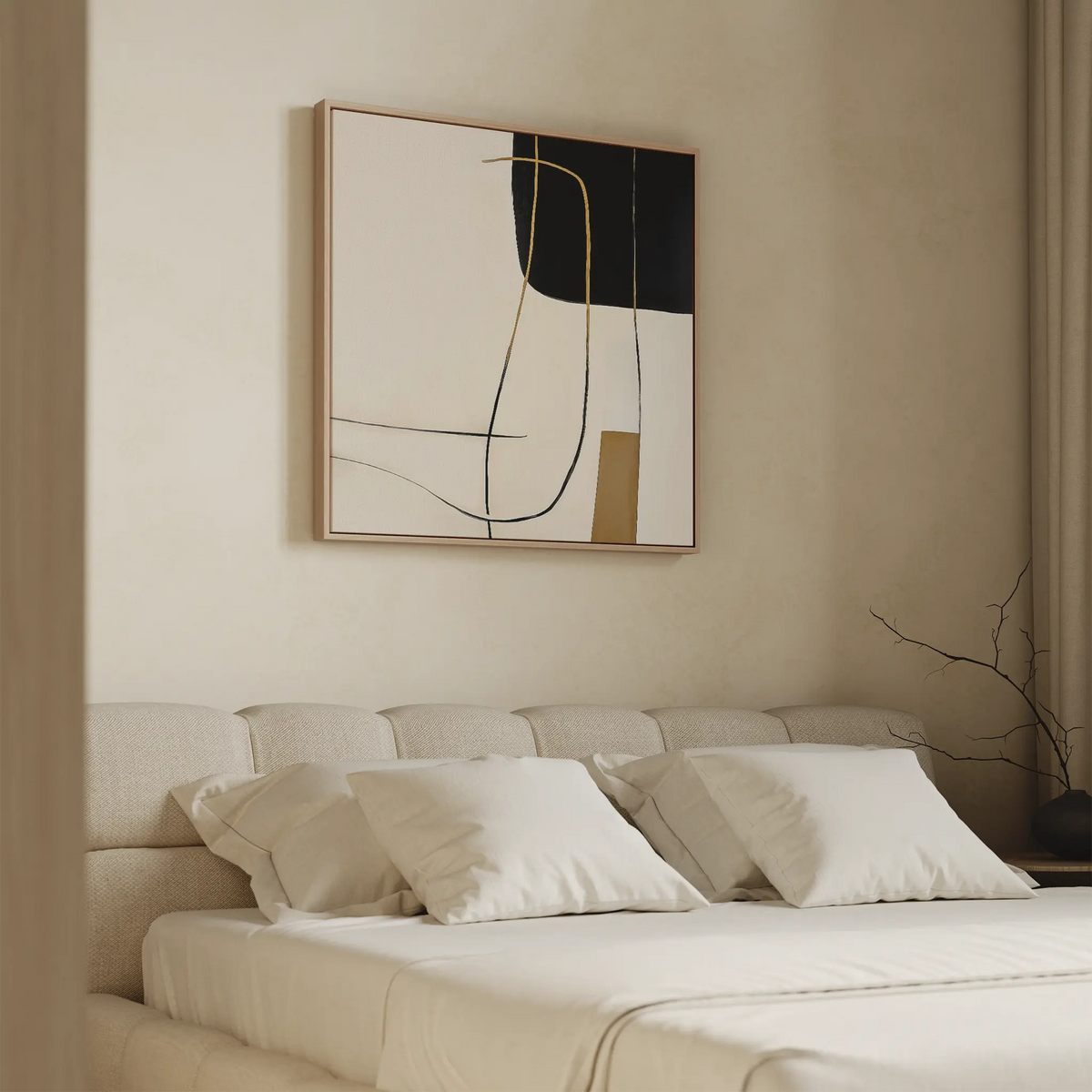 A modern bedroom with minimalist decor features a beige upholstered bed, white bedding, and Golden Thread Canvas Art in black, beige, white, and gold above the bed. A bare branch in a vase sits on the bedside table.
