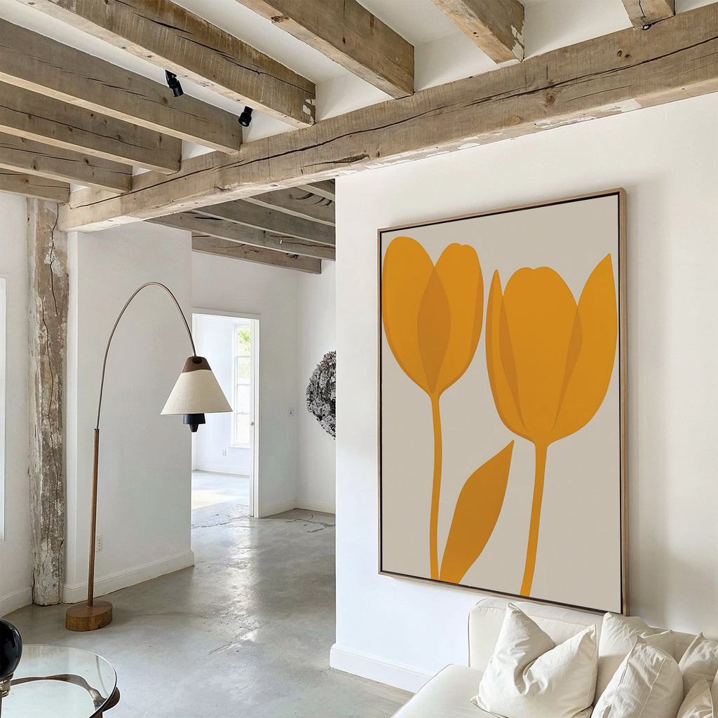 A modern living room with exposed wooden beams and a curved floor lamp features Golden Tulips Abstract Canvas Art above a white sofa. Natural light brightens the minimalist space, enhancing the contemporary decor.
