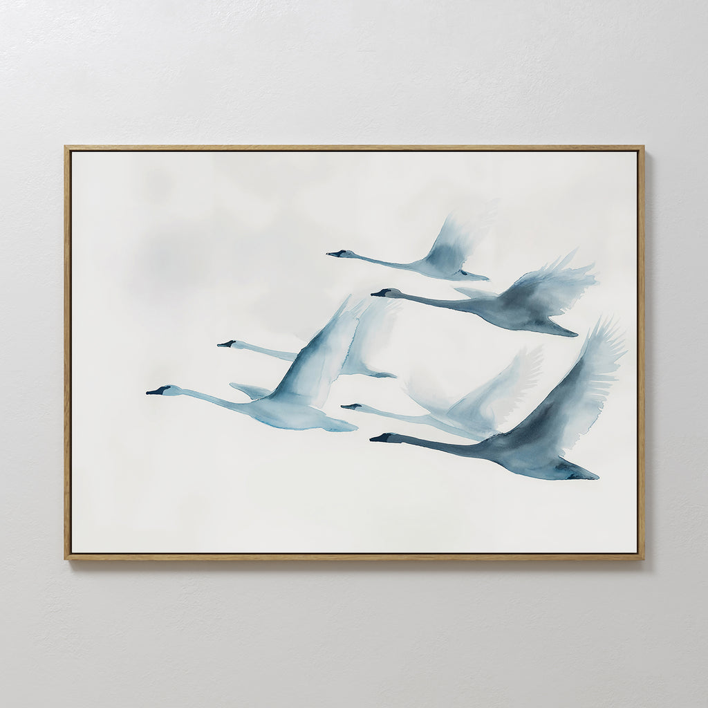 Graceful Flock Canvas Art showcases six blue-toned swans flying in formation on a white background, featuring soft watercolor brushstrokes—a stylish modern nature decor piece ideal for fans of Nordic wall art.