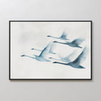 The Graceful Flock Canvas Art features six swans in flight against a gentle background, bringing serene Nordic style and modern nature decor to any plain white wall.