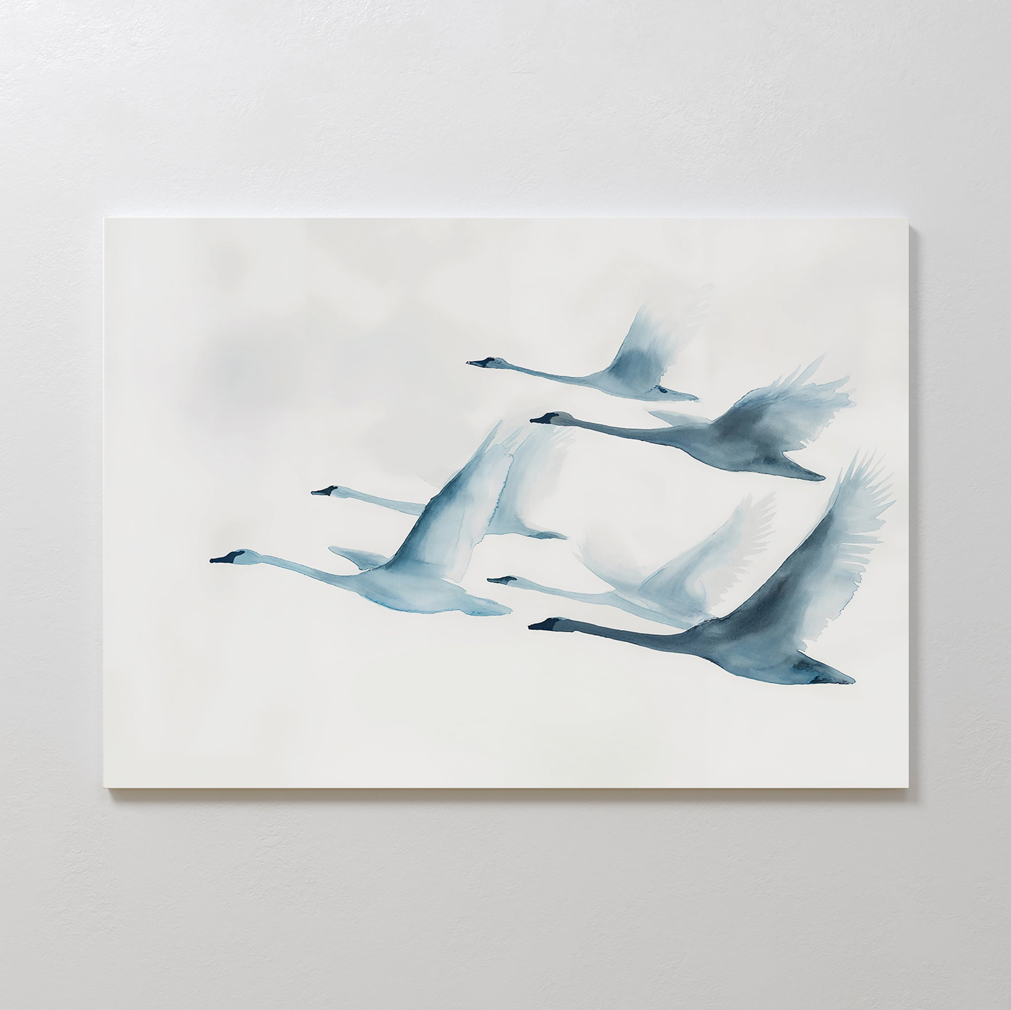 Graceful Flock Canvas Art features a minimalist watercolor of six swans in flight, painted in soft blue and gray on a light background—ideal for modern nature decor or as elegant Nordic wall art.