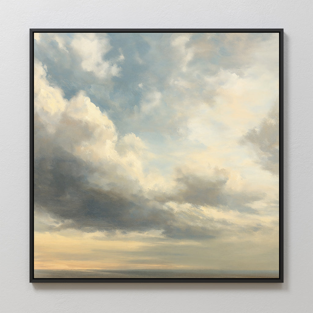The Heavenly Drift Canvas Art features a framed print of a cloudy sky with soft blue, gray, and cream tones as light breaks through above a faint horizon—an ideal vintage accent for adding serenity to any living room.