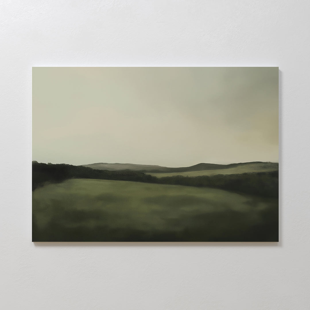 The Hills at Dusk Canvas Art – Horizontal features a minimalist misty landscape with rolling green hills beneath a cloudy sky. Its soft, blurred edges create a calming vibe—ideal as wall art print or living room decor.