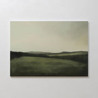The Hills at Dusk Canvas Art – Horizontal features a minimalist misty landscape with rolling green hills beneath a cloudy sky. Its soft, blurred edges create a calming vibe—ideal as wall art print or living room decor.