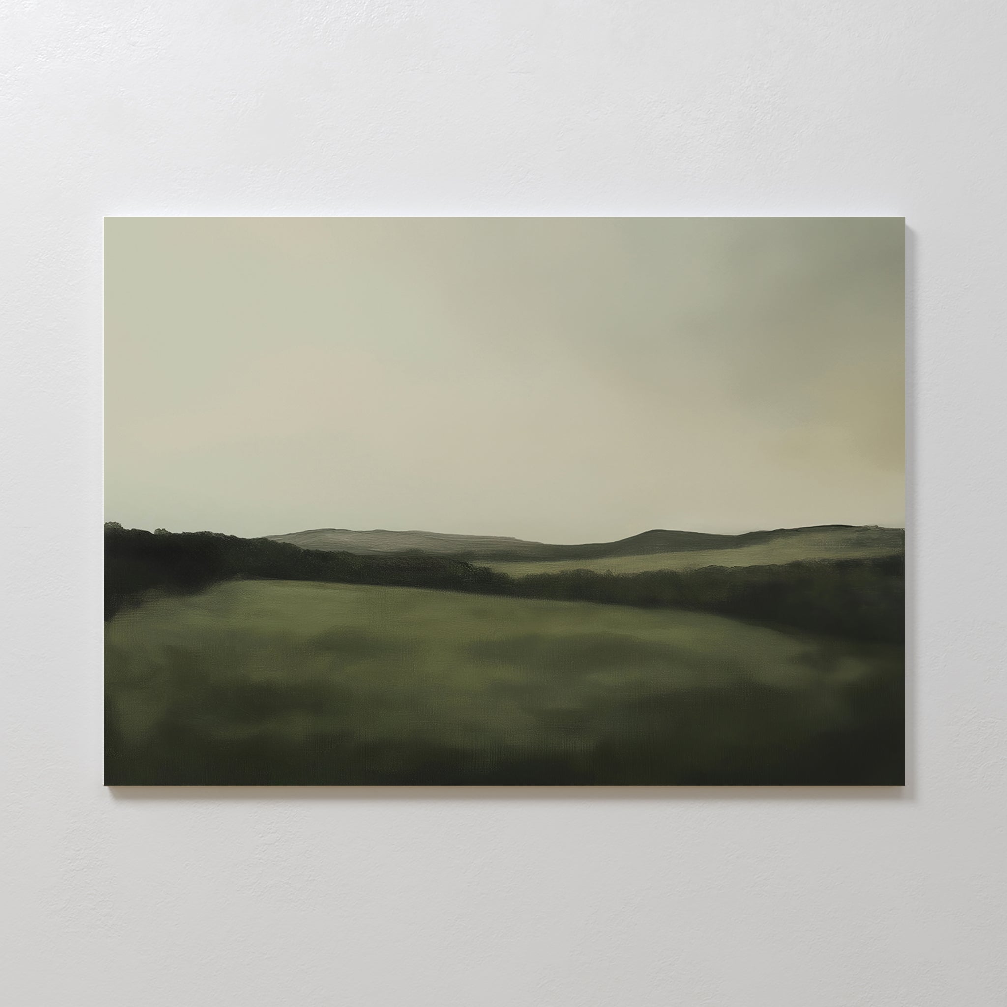 The Hills at Dusk Canvas Art – Horizontal features a minimalist misty landscape with rolling green hills beneath a cloudy sky. Its soft, blurred edges create a calming vibe—ideal as wall art print or living room decor.