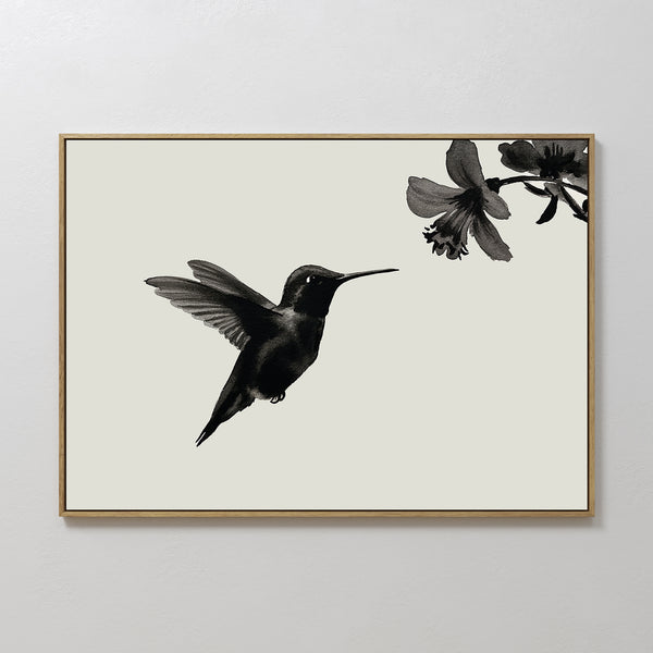 Hummingbird Motion Canvas Art features a minimalist black hummingbird in flight near a flower, set on a light background with a thin frame—ideal for modern decor and minimalist wall art collections.