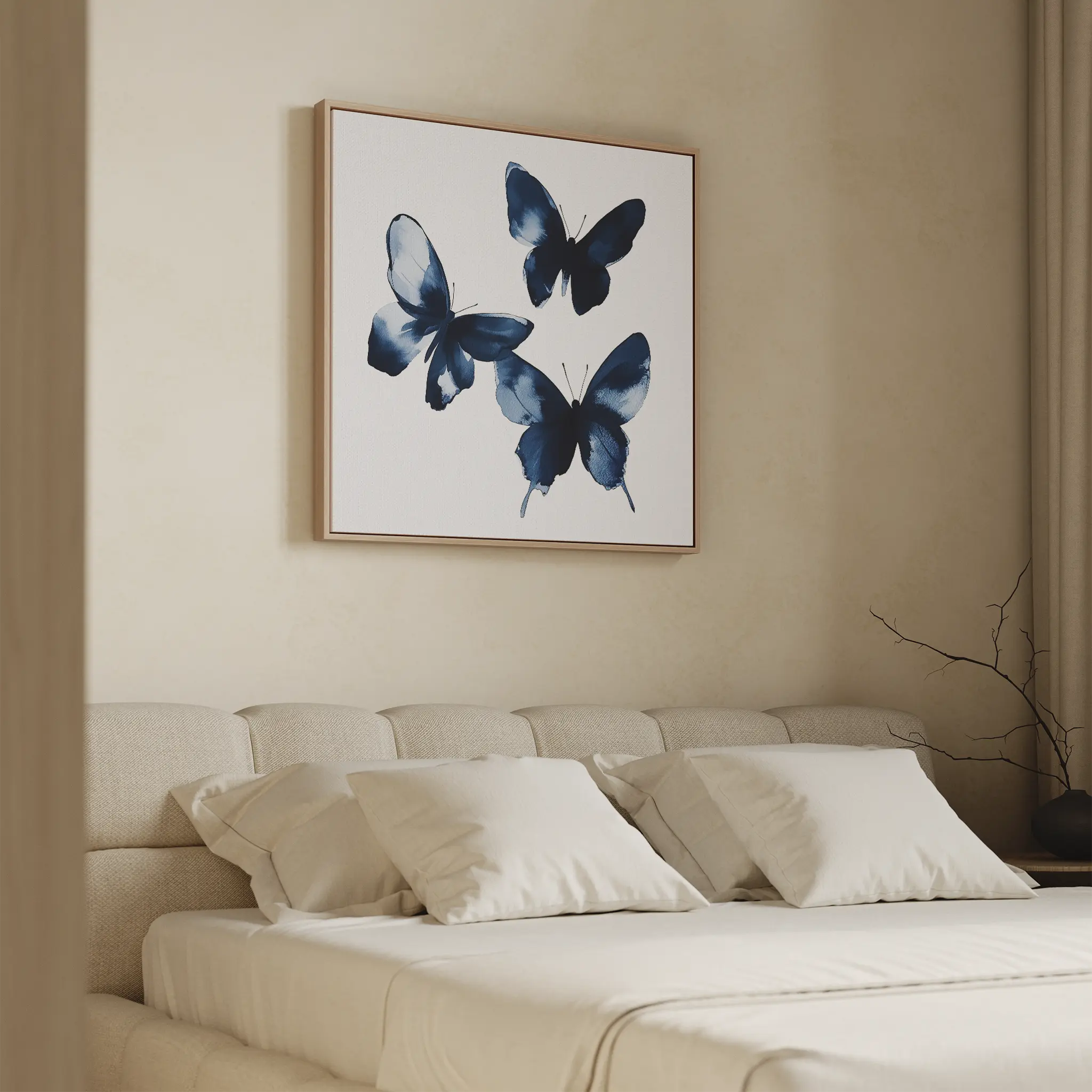 A minimal bedroom features a beige upholstered bed with white pillows and the Indigo Flutter Canvas Art above the headboard. A bare branch in a vase on the bedside table enhances the modern home decor.