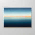 The Indigo Passage Canvas Art – Horizontal features a minimalist ocean under a gradient sky, blending deep blue to pale orange—ideal wall art to create a serene, peaceful vibe in any modern living room.