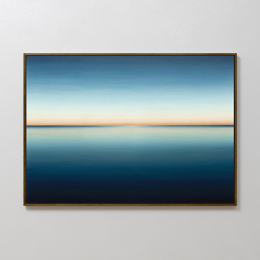 The Indigo Passage Canvas Art – Horizontal showcases a calm blue ocean under a gradient sky, blending deep blue to light orange. This minimalist wall art is perfect for adding peaceful, modern style to your living room decor.