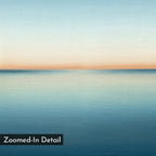 Indigo Passage Canvas Art features a serene, minimalist seascape with soft blue water and a pale orange-blue sky at the horizon. Its smooth, blurred texture brings calm to modern living rooms. Label: “Zoomed-In Detail.”.