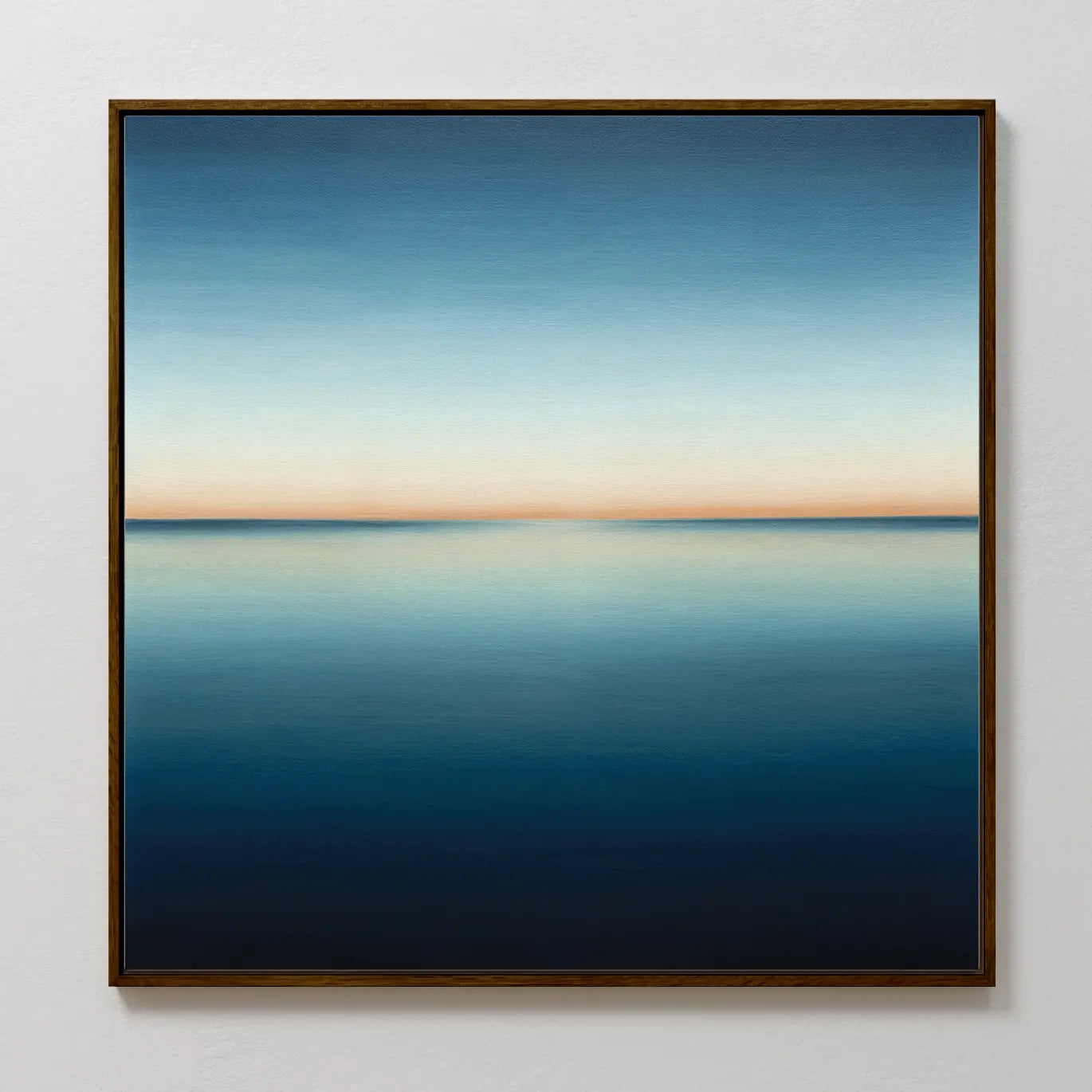 Indigo Passage Canvas Art features a serene seascape with a calm, reflective ocean and a gradient sky from deep blue to soft peach—perfect indigo wall art for enhancing modern living room decor.