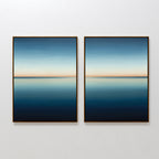The Indigo Passage Set of 2 features minimalist framed wall art of calm water reflecting the sky in deep blue to peach tones—ideal for adding a tranquil, modern touch to your living room decor.