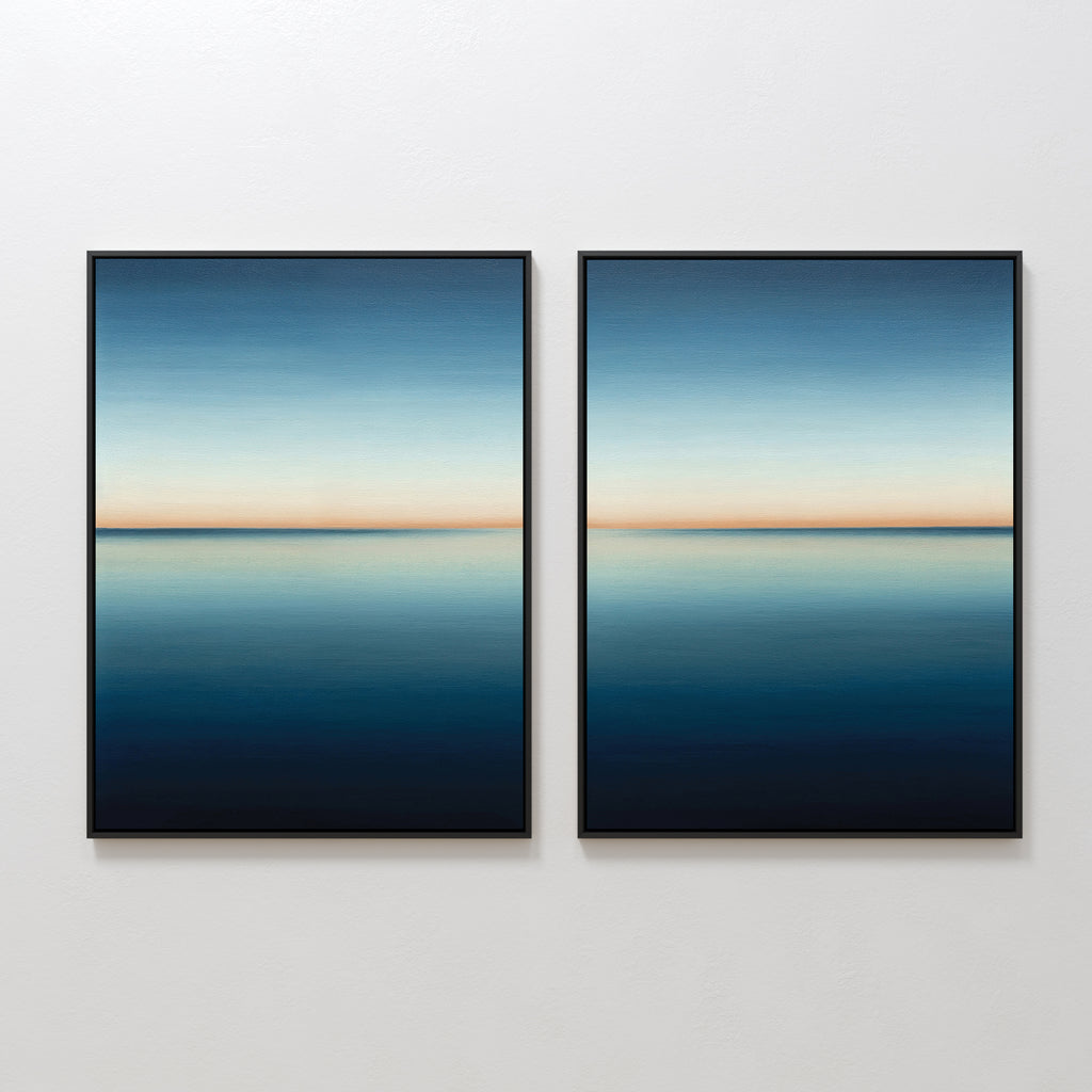 The Indigo Passage Set of 2 features framed paintings of a serene blue seascape with a clear horizon, hung side by side. This minimalist wall art adds tranquility and is ideal for enhancing modern living room decor.