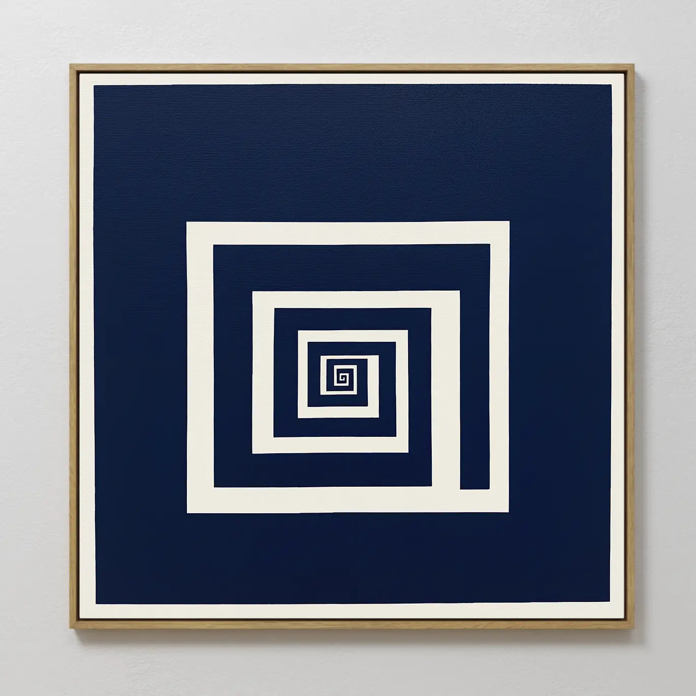The Infinite Descent Canvas Art features white square spirals on a dark blue background, creating an optical illusion. Its light wood frame adds a modern touch, making it striking decor for light gray walls.