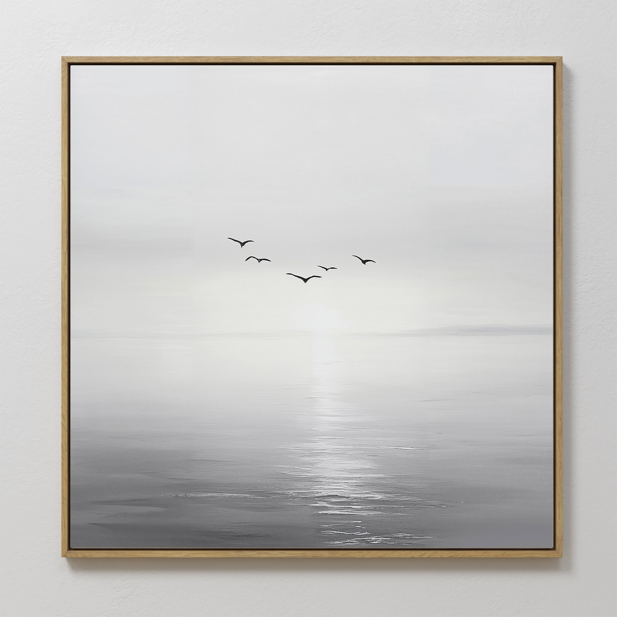 Into the Light Canvas Art features a minimalist calm sea with gentle waves, a bright horizon, and six birds in soft grayscale tones. This large piece comes framed with a thin wooden border—ideal for contemporary living room decor.