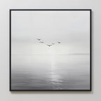 Into the Light Canvas Art features a minimalist design of five birds soaring above a tranquil sea beneath a pale sky—perfect for creating a serene and calming atmosphere in your living room.