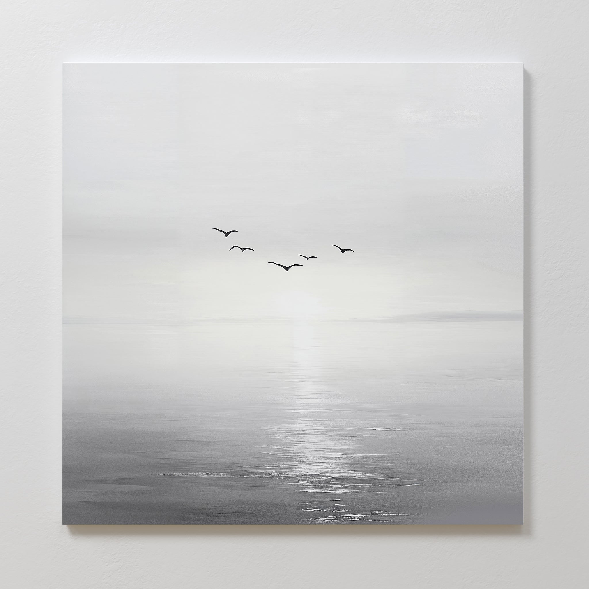 Into the Light Canvas Art features a minimalist black and white ocean scene with calm waters, a bright horizon, and six soaring birds—ideal for adding serene vibes to your living room décor.