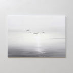 Into the Light Canvas Art – Horizontal features a minimalist, gray-toned seascape with five birds flying above gentle water, ideal as large wall art to create a serene ambiance in your living room on a plain white wall.