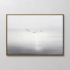 Into the Light Canvas Art – Horizontal features a calm, misty seascape in muted grays with six birds above the water, making it an ideal minimalist wall art piece for serene living room decor.