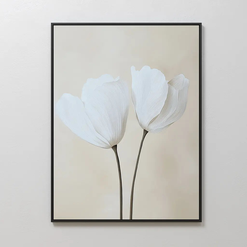 The Ivory Buds Canvas Art showcases two white flowers with slender stems on a soft beige background, framed in black—ideal floral wall art for neutral-toned interiors and beautifully displayed on a light-colored wall.