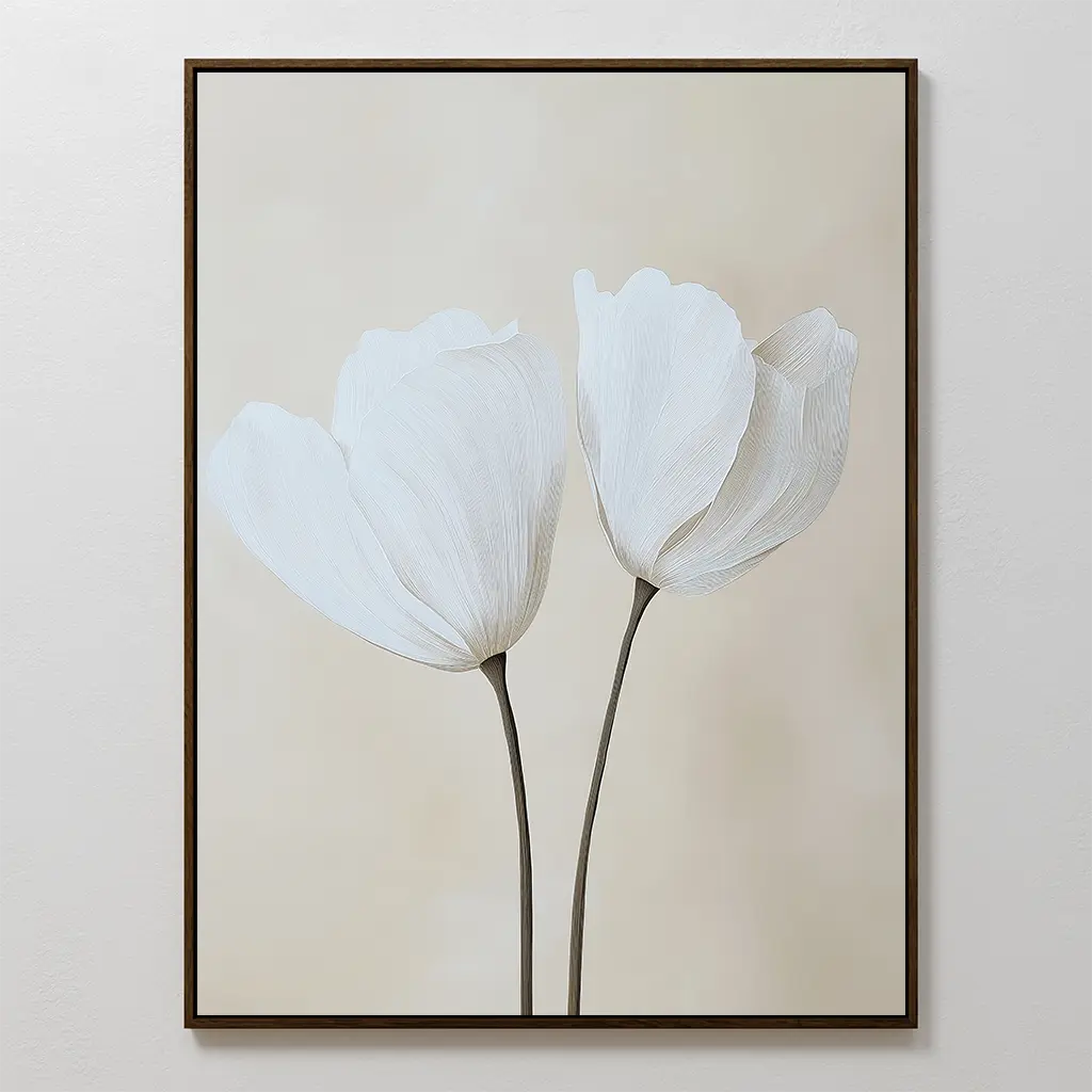 Ivory Buds Canvas Art features two white tulips with long stems on a soft beige background, framed in a thin dark frame. This minimalist floral wall art perfectly complements neutral-toned interiors with its simple elegance.