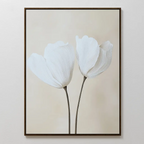 Ivory Buds Canvas Art features two white tulips with long stems on a soft beige background, framed in a thin dark frame. This minimalist floral wall art perfectly complements neutral-toned interiors with its simple elegance.