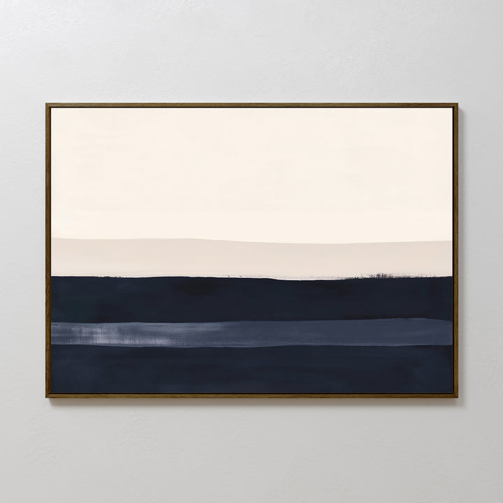 The Ivory Dusk Canvas Art – Horizontal features abstract cream, beige, and navy bands with soft edges in a simple dark frame, adding sophisticated style and making a striking statement on light gray walls in modern interiors.