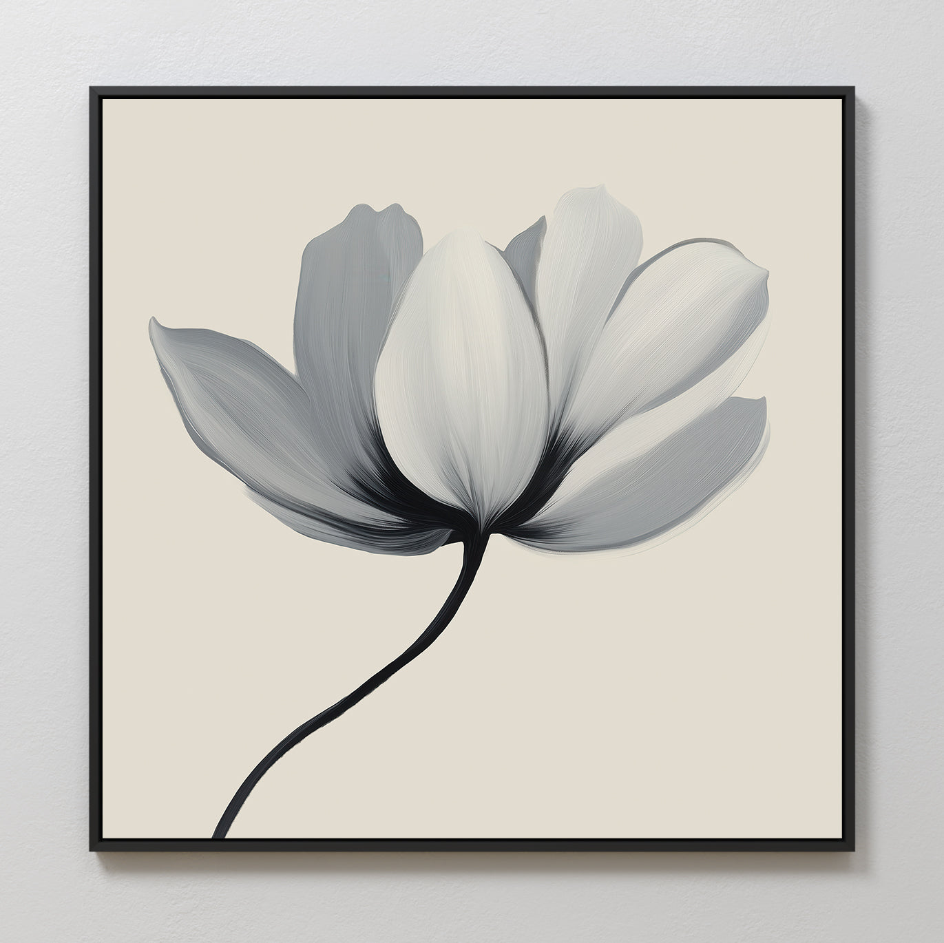 The Ivory Petal Canvas Art features a single flower with soft grey and white petals on a cream background, framed in black—ideal as minimalist floral wall art or elegant bedroom decor.