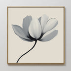 Ivory Petal Canvas Art showcases a single flower with white and gray petals and a black stem on a light beige background, framed in slim light wood—perfect as elegant floral wall art for bedroom decor.