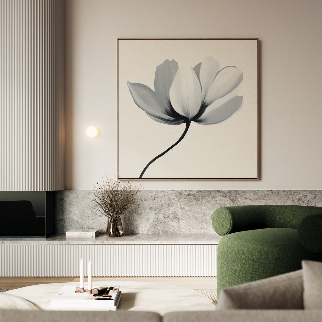 A modern living room featuring the Ivory Petal Canvas Art, a green curved sofa, minimalist decor, a vase with dried branches, marble surfaces, and a light coffee table with candles and a small stack of books.