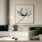 A modern living room featuring the Ivory Petal Canvas Art, a green curved sofa, minimalist decor, a vase with dried branches, marble surfaces, and a light coffee table with candles and a small stack of books.