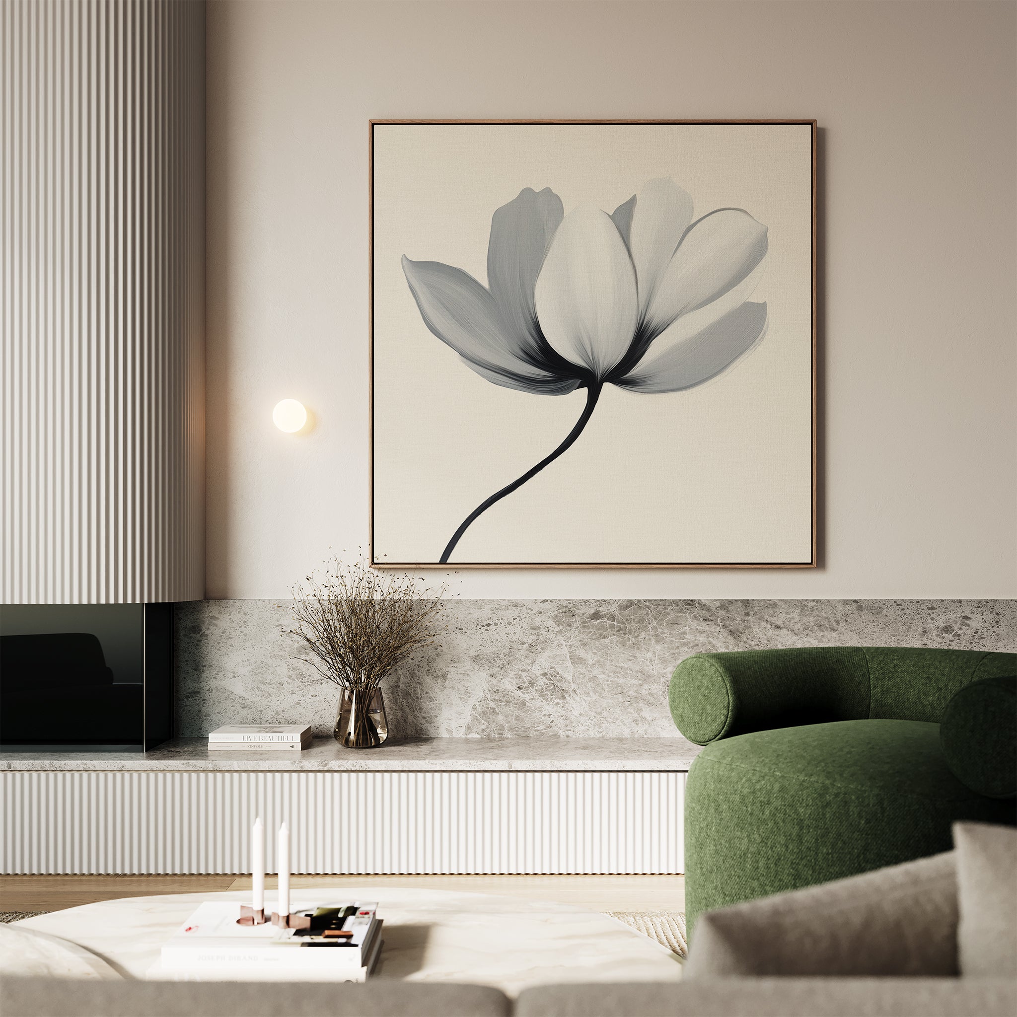 A modern living room featuring the Ivory Petal Canvas Art, a green curved sofa, minimalist decor, a vase with dried branches, marble surfaces, and a light coffee table with candles and a small stack of books.