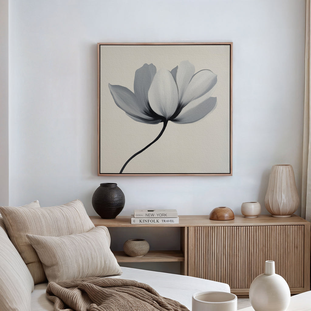 A minimalist living room featuring a beige sofa, neutral cushions, a wooden cabinet with decorative vases, and the Ivory Petal Canvas Art displayed above. Soft natural light filters in through a window dressed with light curtains.