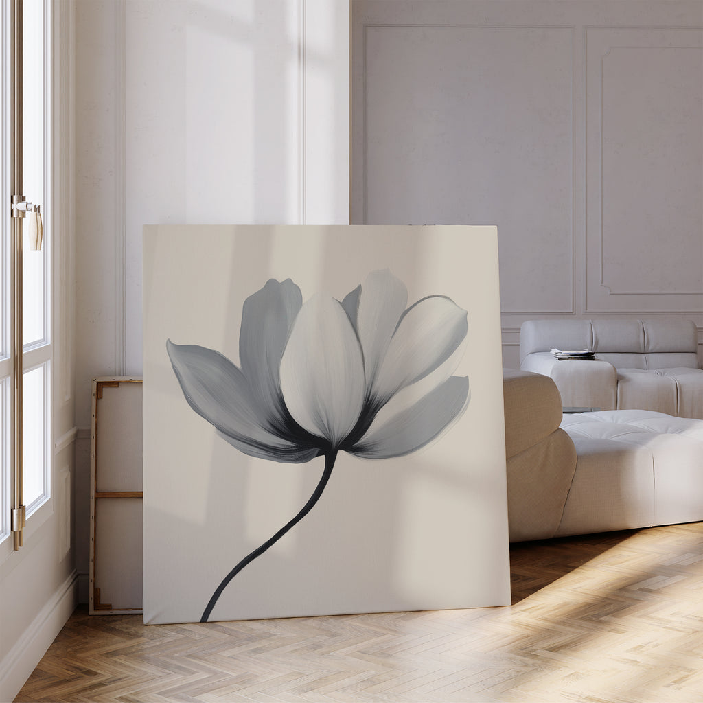 The Ivory Petal Canvas Art leans against the wall in a bright, modern living room with a beige sofa, wooden herringbone floors, and sunlight streaming through tall windows.