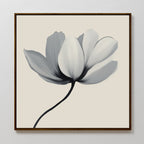Ivory Petal Canvas Art features a minimalist white magnolia with gray shading on a beige background, framed in dark wood—an elegant floral wall art piece to elevate your bedroom decor.