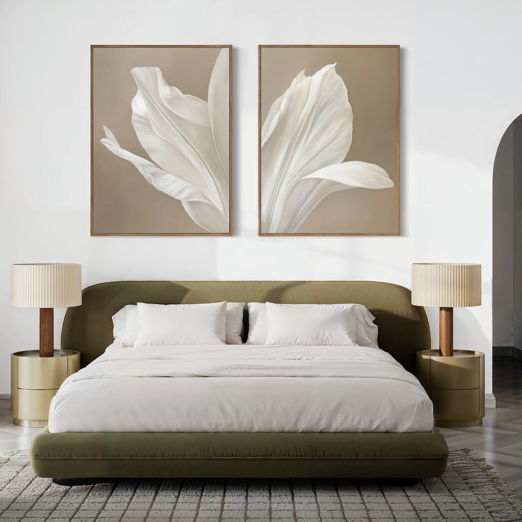 A modern bedroom with a low olive-green bed frame, white bedding, two beige nightstands with matching lamps, and minimalist wall art—the Ivory Petals Set of 2 featuring white flowers displayed above the bed.